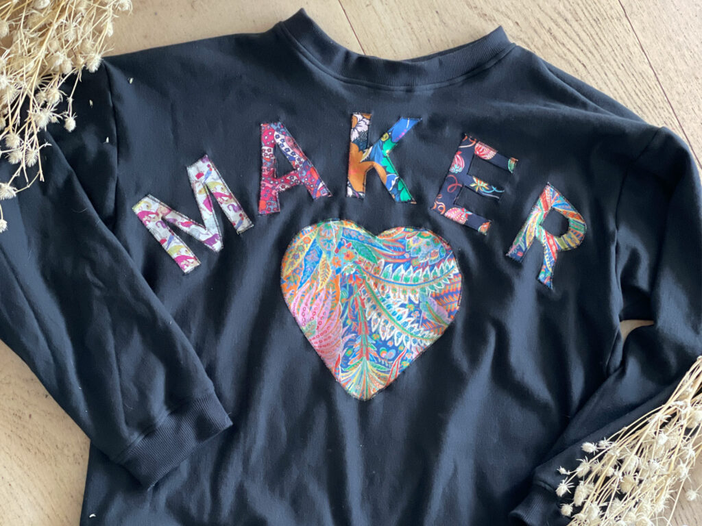 the maker sweater on a table