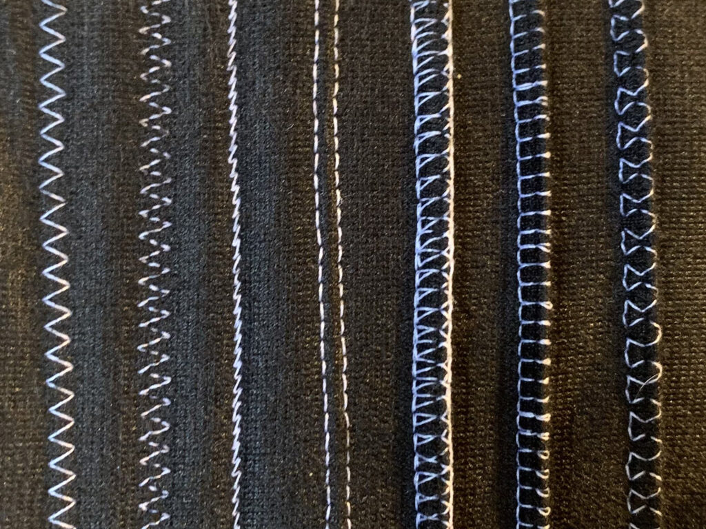 Stretch stitches sewn on Pfaff. From left to right: zig zag stitch, three-step zig zag stitch, stretch tricot stitch, twin needle, closed overlock, elastic overcast, stretch knit overlock.
